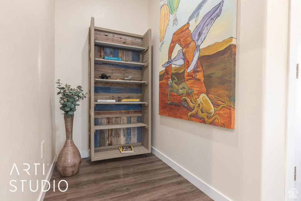 Hall with dark wood finished floors and baseboards