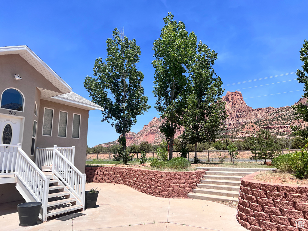 View of patio with a mountain view and stairway