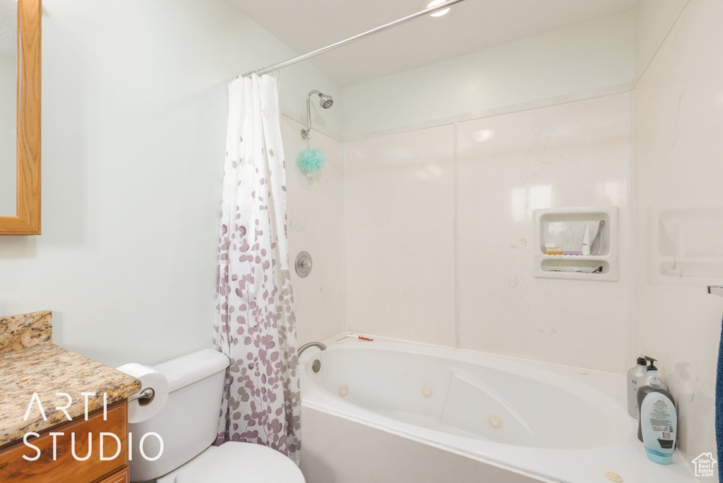 Full bathroom with a combined bath / shower with jetted tub and vanity