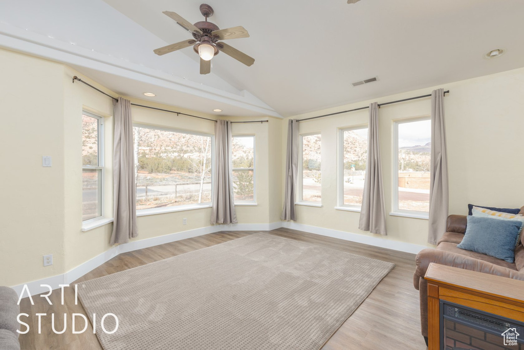 Sunroom / solarium featuring vaulted ceiling