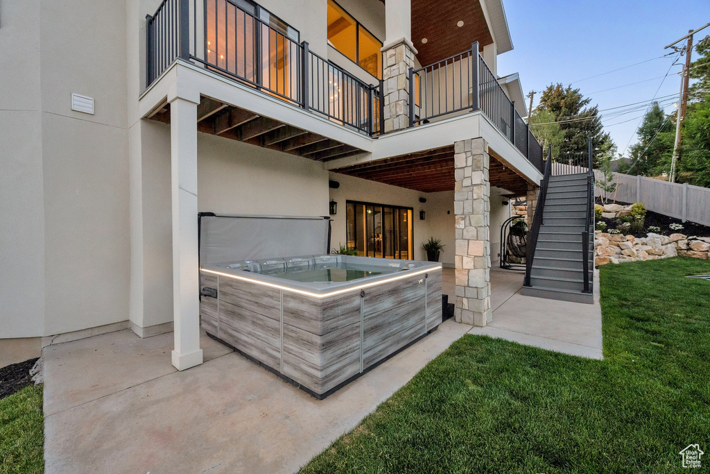 Patio / terrace featuring a hot tub, stairs, and a patio area