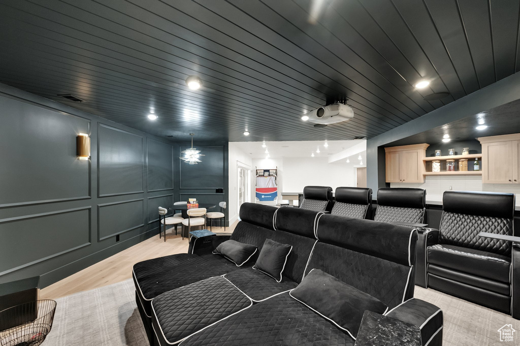 Cinema with a decorative wall and light wood finished floors