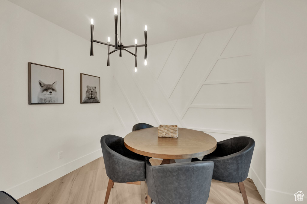 Dining space with a chandelier and light wood-style flooring