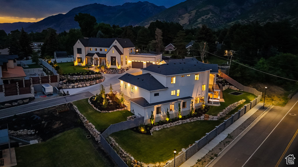 Aerial view of property and surrounding area with a mountainous background