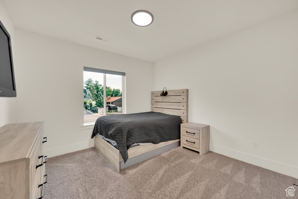 Bedroom with light colored carpet