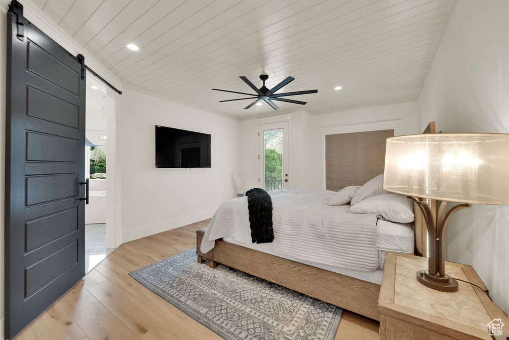 Bedroom featuring a barn door, light wood finished floors, recessed lighting, wood ceiling, and ceiling fan