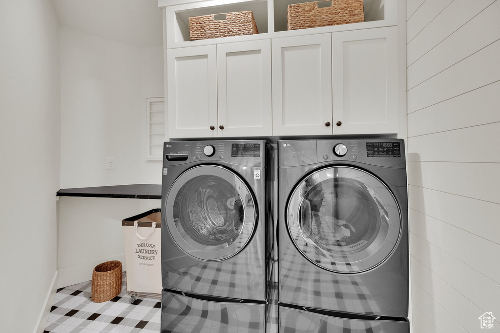 Washroom with cabinet space and separate washer and dryer