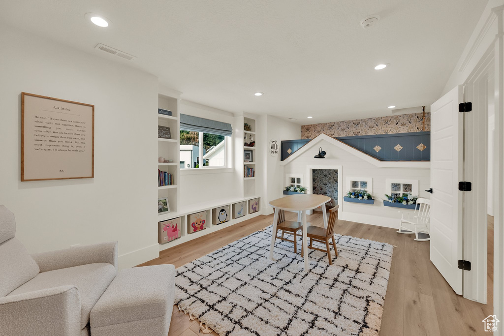Office space with light wood-type flooring, built in features, and recessed lighting
