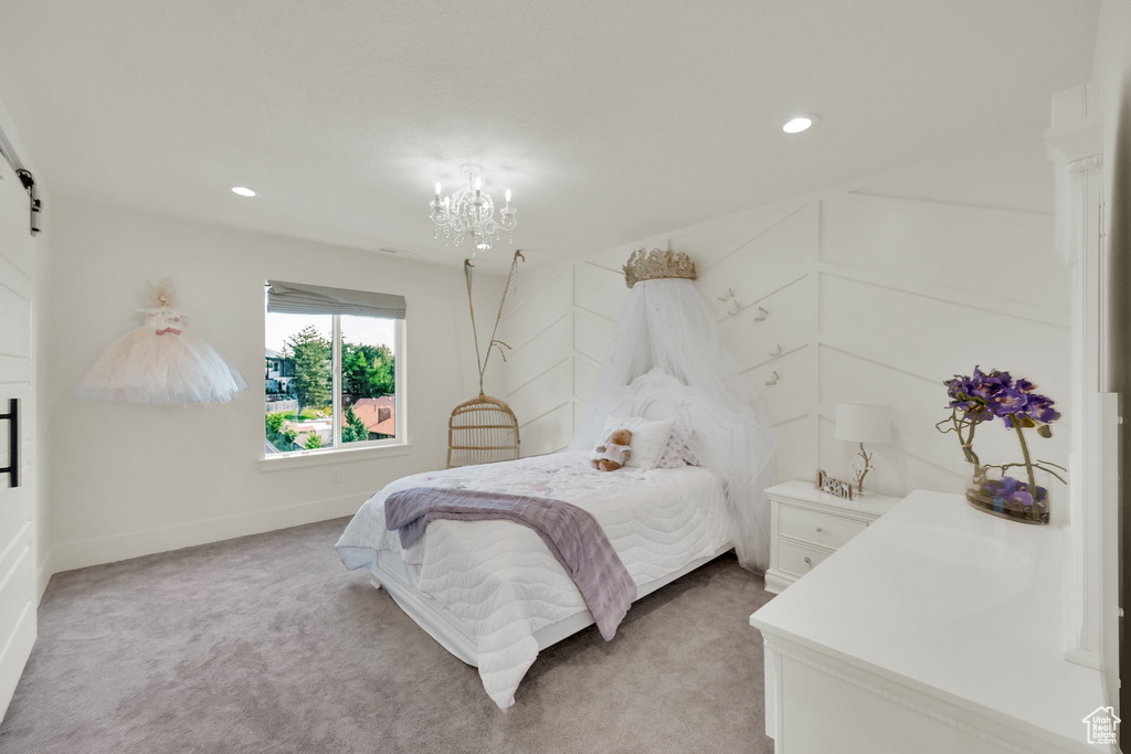 Bedroom featuring light carpet, a barn door, a chandelier, and recessed lighting