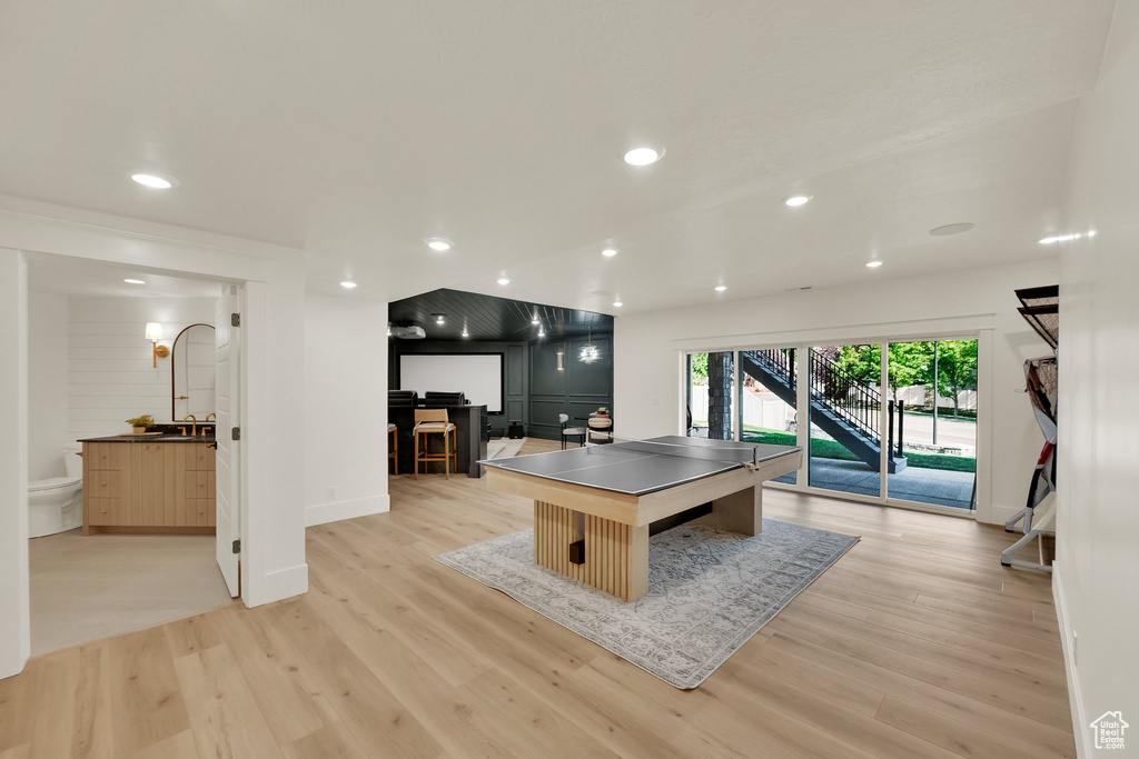 Game room with light wood-style flooring and recessed lighting
