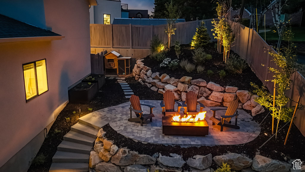 Fenced backyard with a fire pit and a patio