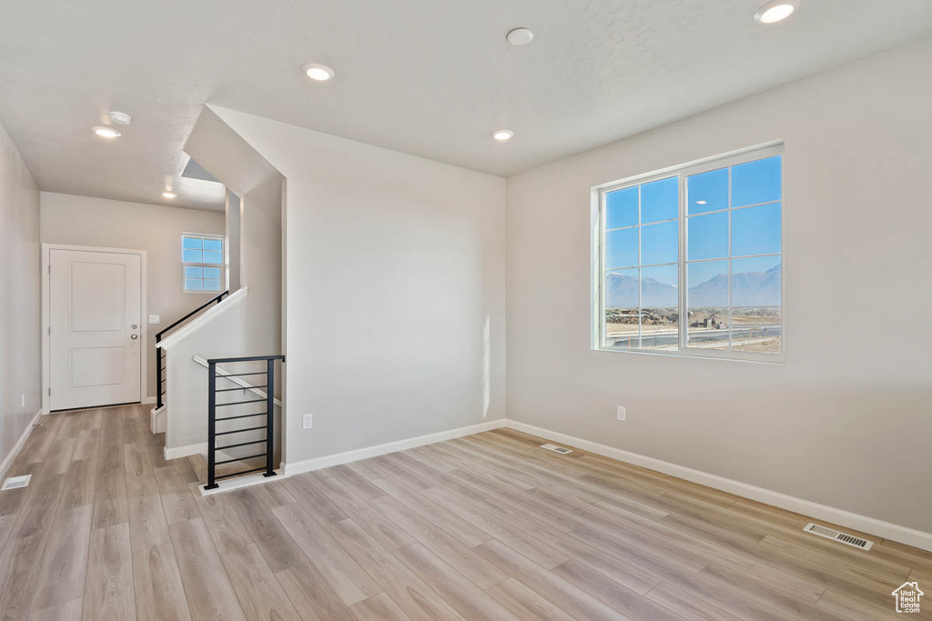 Spare room with light wood-style flooring and recessed lighting