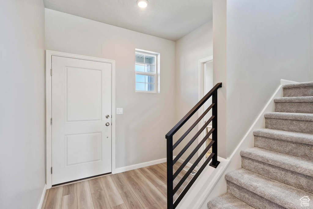 Entrance foyer featuring light wood-style floors and stairs