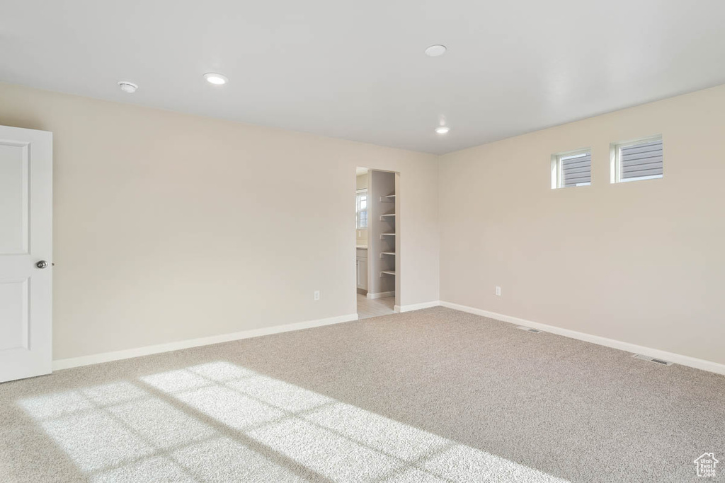 Carpeted spare room featuring baseboards and recessed lighting