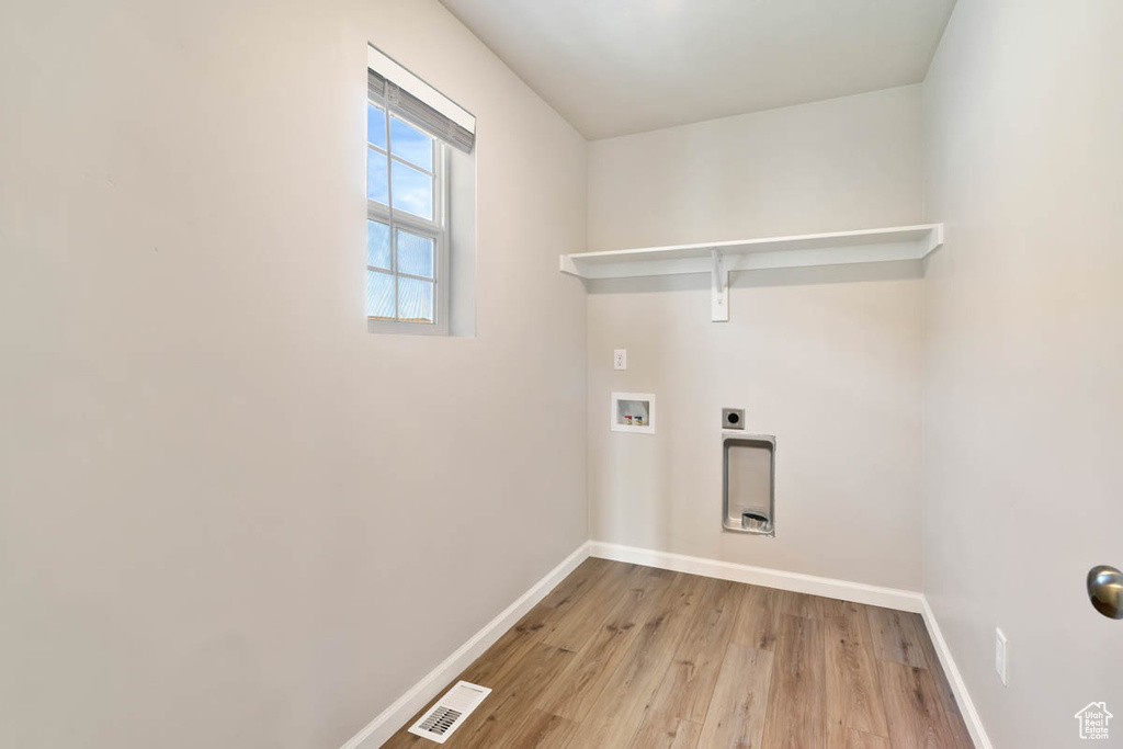 Laundry room featuring washer hookup, light wood-style floors, and electric dryer hookup