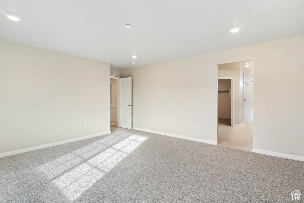 Spare room featuring light carpet and recessed lighting