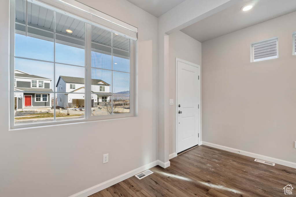 Unfurnished room with baseboards and wood finished floors