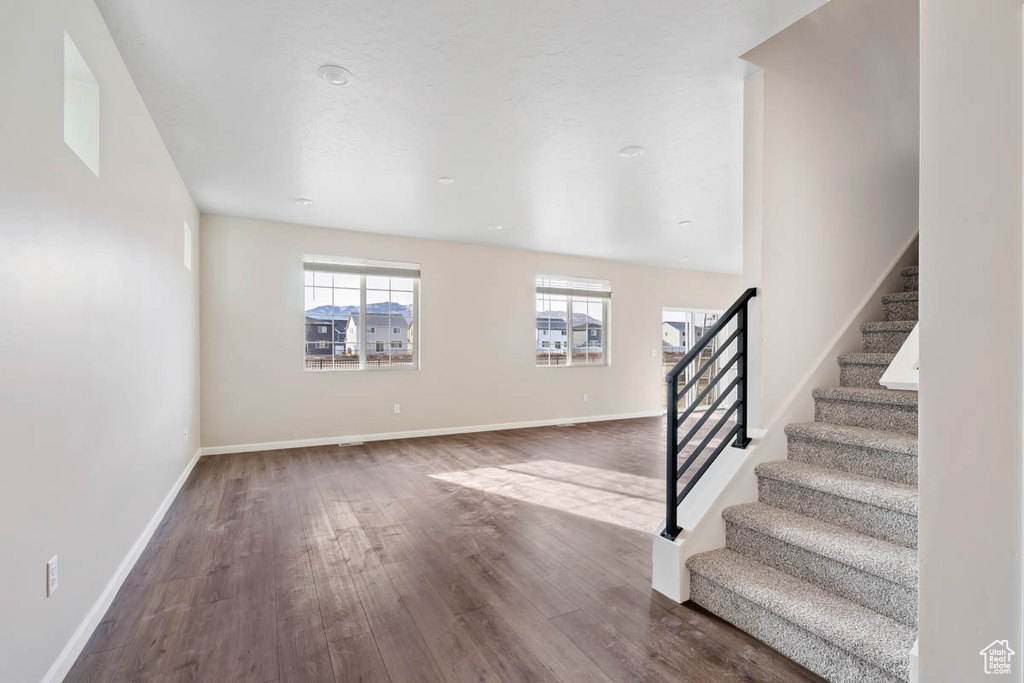 Entryway with wood finished floors and stairs