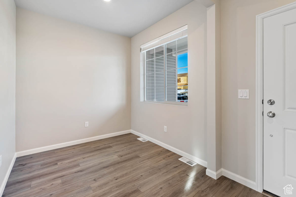 Unfurnished room featuring wood finished floors and baseboards