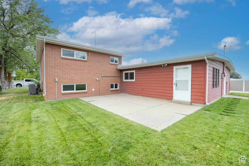 Back of house with a patio area and brick siding