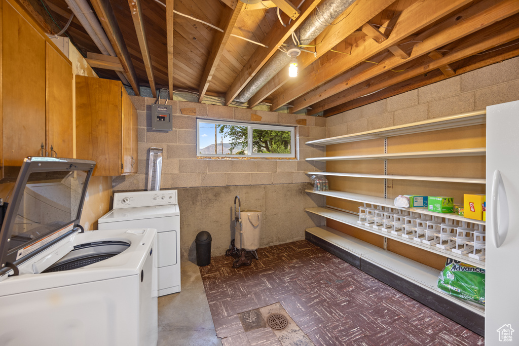 Laundry room featuring independent washer and dryer, tile patterned floors, and electric panel