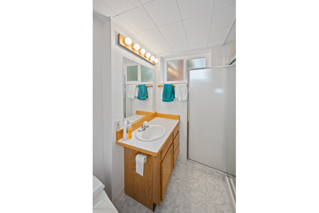 Bathroom featuring a stall shower and vanity