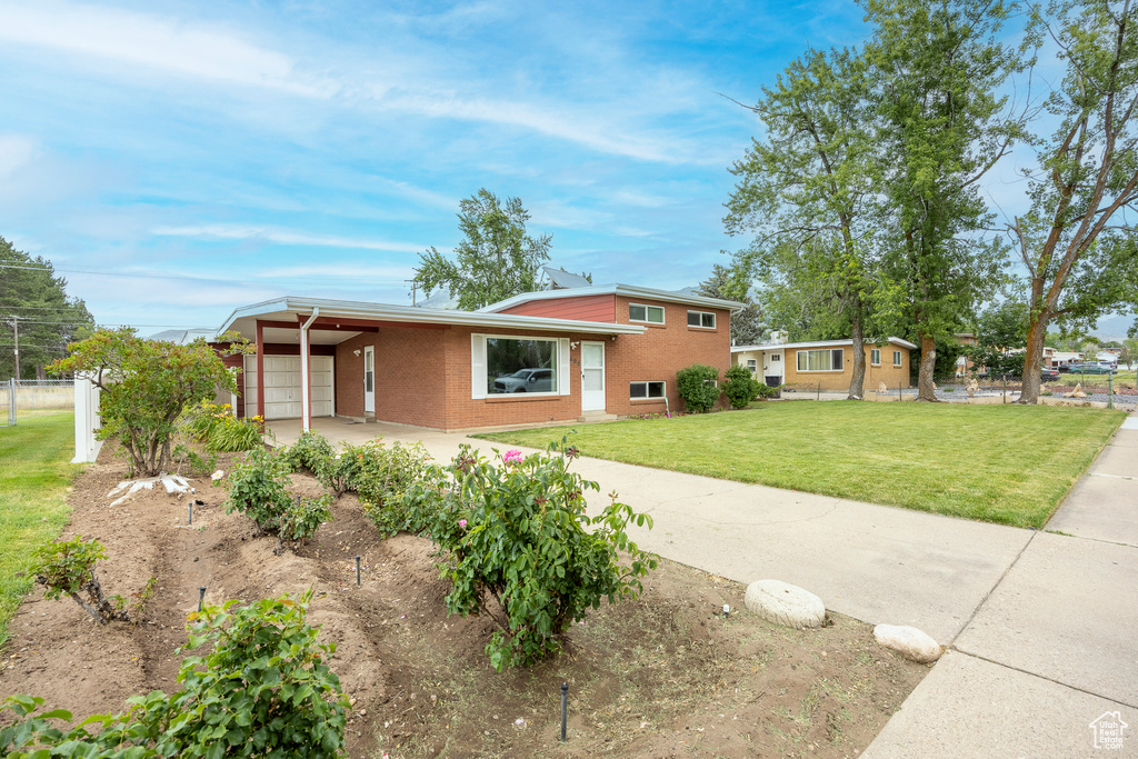 Tri-level home with brick siding and a garage