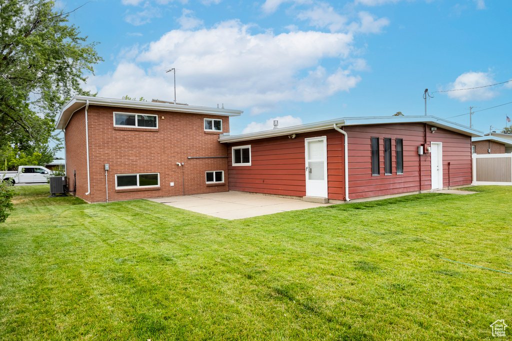 Back of house with a patio area and brick siding