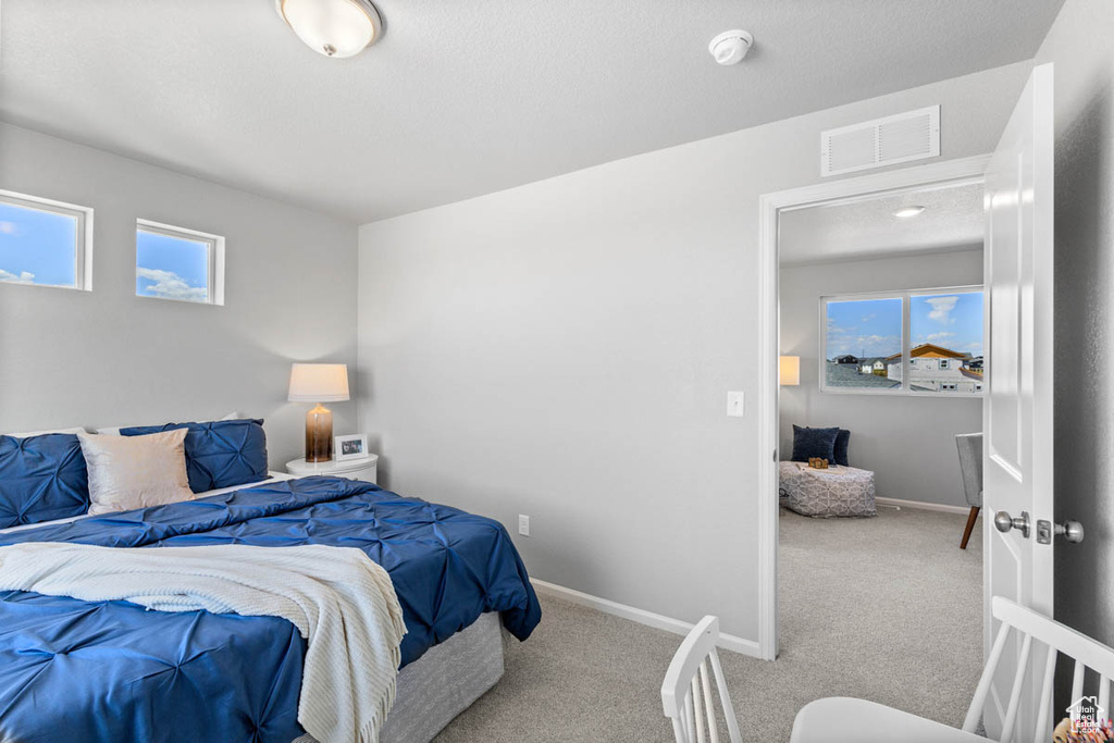 Carpeted bedroom with baseboards