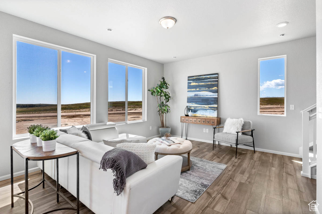 Living area with baseboards and wood finished floors
