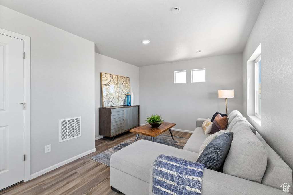 Living room with wood finished floors and recessed lighting