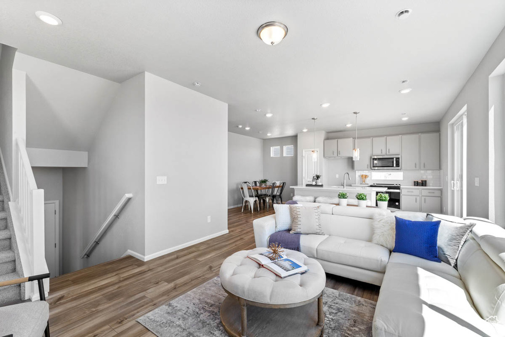 Living area featuring wood finished floors and recessed lighting