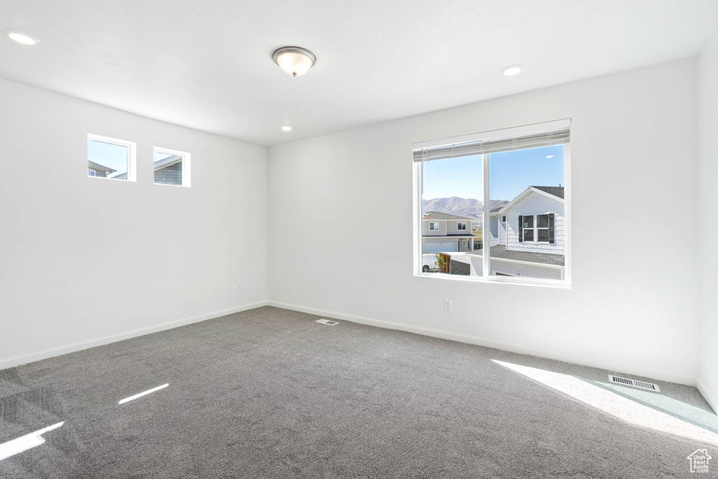 Spare room featuring carpet flooring and recessed lighting