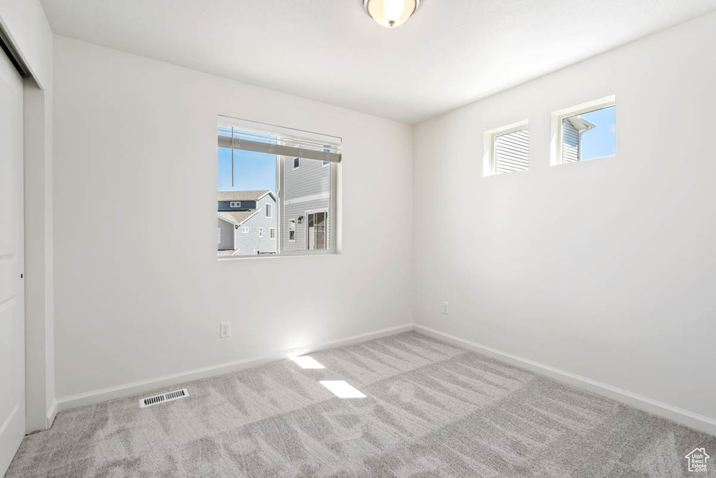 Unfurnished bedroom with carpet flooring and a closet