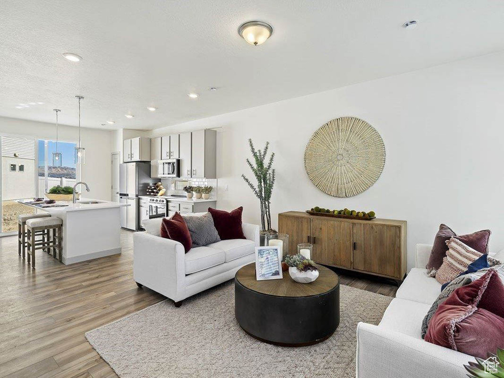 Living room featuring light wood-style floors and recessed lighting