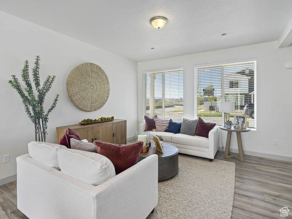 Living area with wood finished floors and a textured ceiling