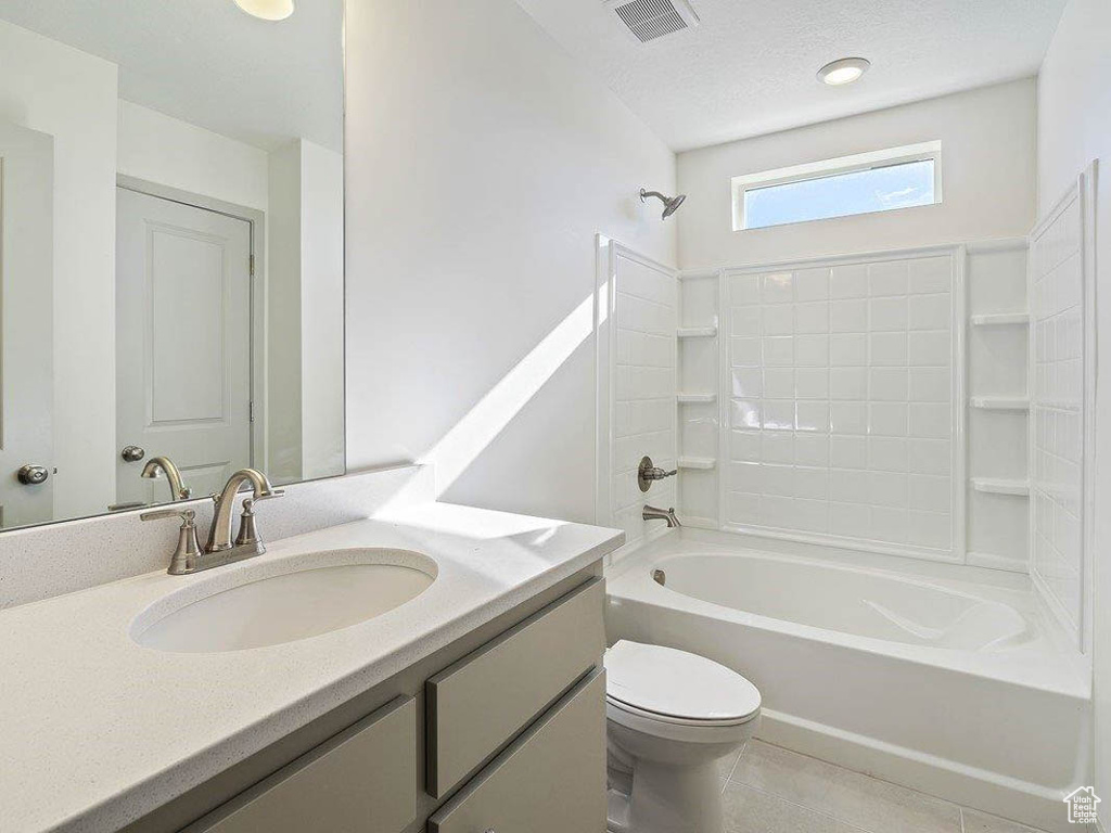 Full bathroom with  shower combination, vanity, tile patterned flooring, and a textured ceiling