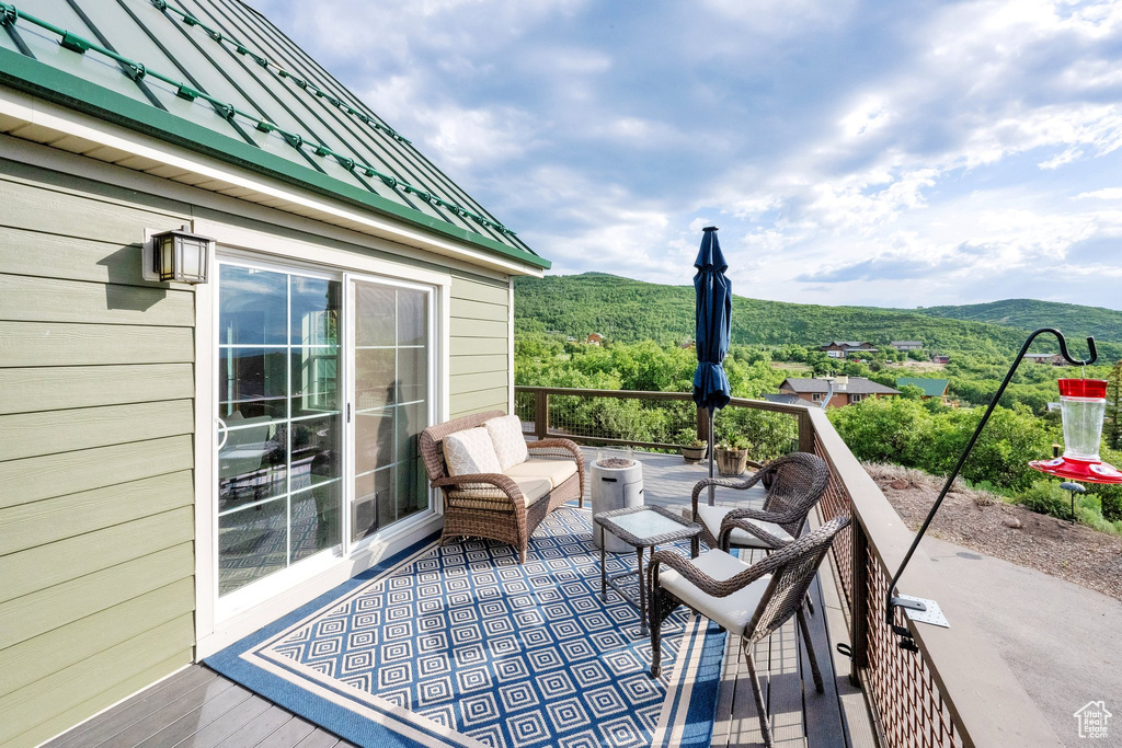 Wooden terrace featuring a mountain view