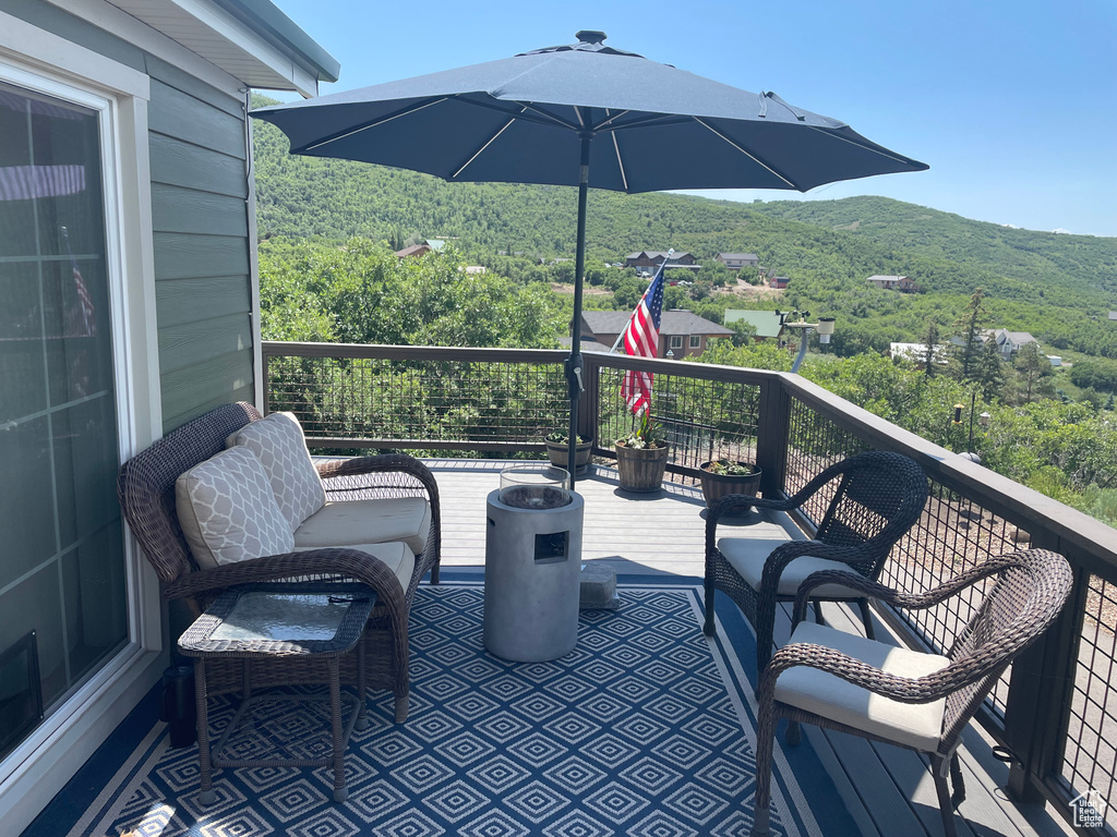Patio / terrace with a view of trees and a mountain view