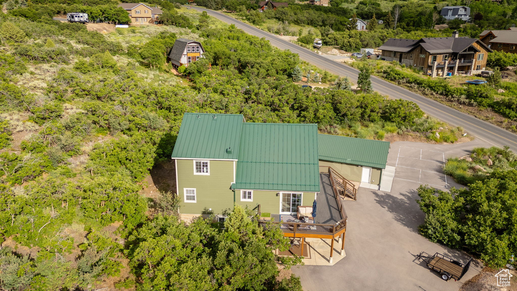 View from above of property with a tree filled landscape