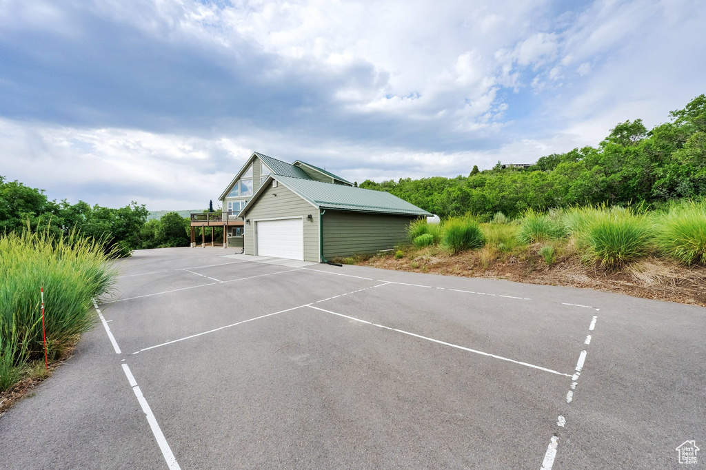 View of home\'s exterior featuring a metal roof and uncovered parking