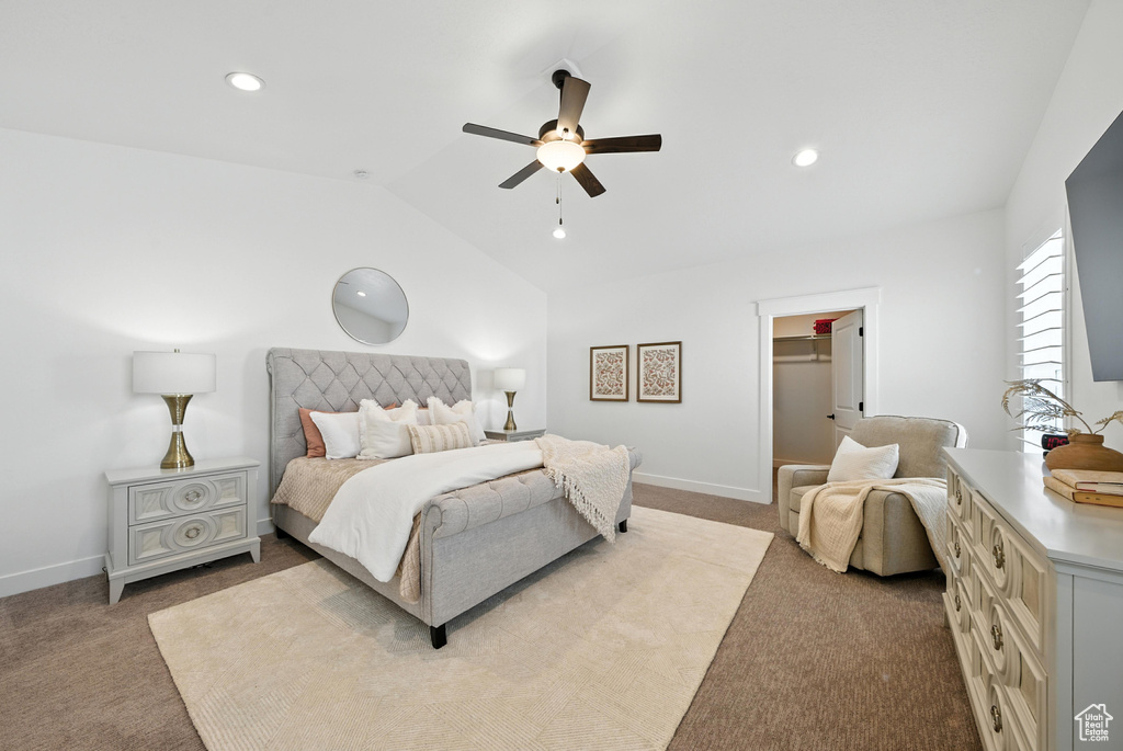 Carpeted bedroom featuring lofted ceiling, a spacious closet, ceiling fan, and recessed lighting
