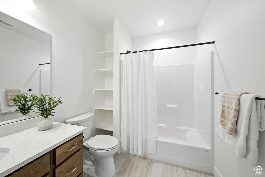 Full bath featuring vanity and shower / bath combination with curtain