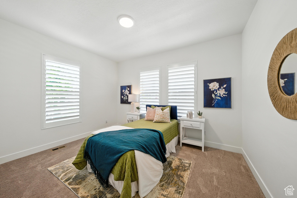 Carpeted bedroom featuring baseboards