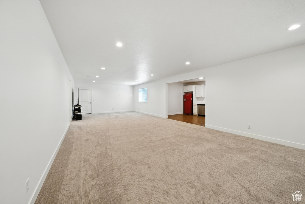 Unfurnished living room featuring carpet flooring and recessed lighting