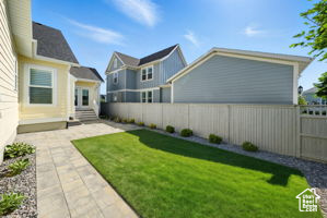 Fenced backyard with a patio area and entry steps