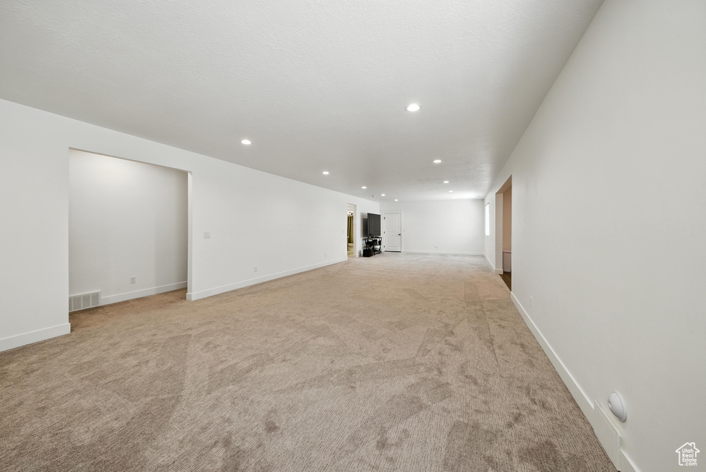 Unfurnished living room with recessed lighting and light carpet