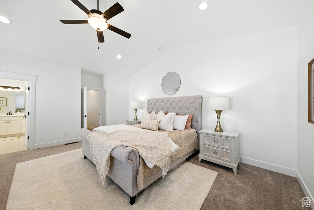 Bedroom with light colored carpet, lofted ceiling, recessed lighting, ensuite bathroom, and a ceiling fan