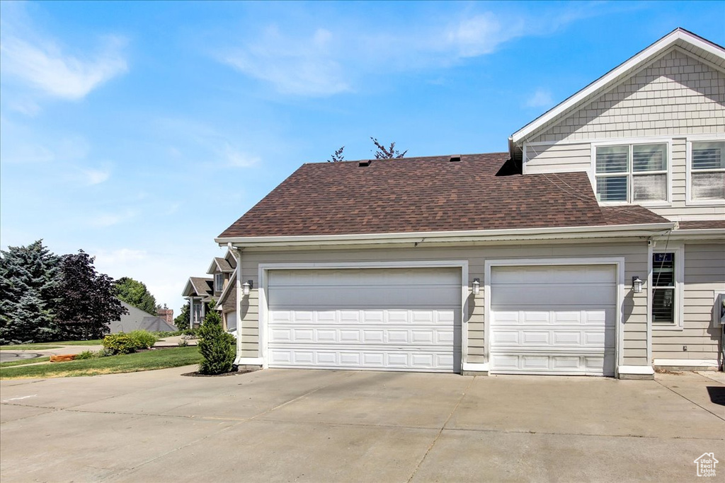 Garage featuring concrete driveway