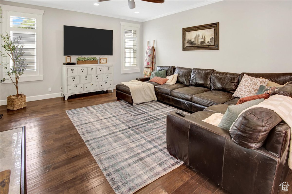 Living area featuring ceiling fan, plenty of natural light, dark wood finished floors, ornamental molding, and recessed lighting